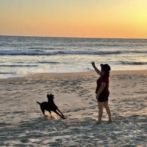 casitas pacifico woman play with her dog at the beach